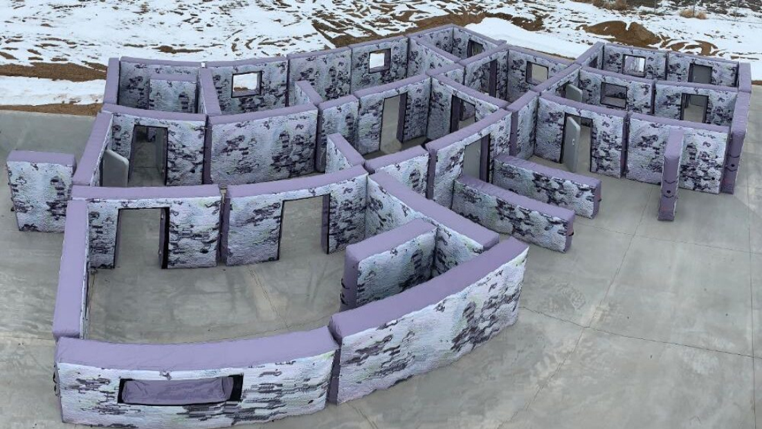 Inflatable and portable walls configured to resemble the interior of a house or building for shooting practice.